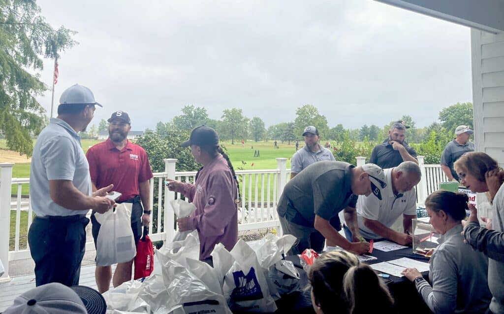 Golfers register and gather at the 2024 Outing
