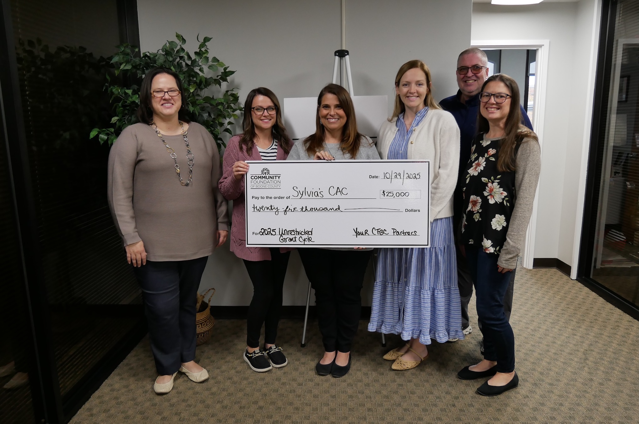 Staff at the Community Foundation of Boone County pose with CAC staff receiving a large check.